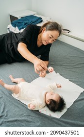 Young Grandma Holding A Newborn Baby