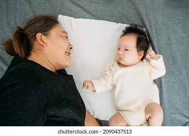 Young Grandma Holding A Newborn Baby