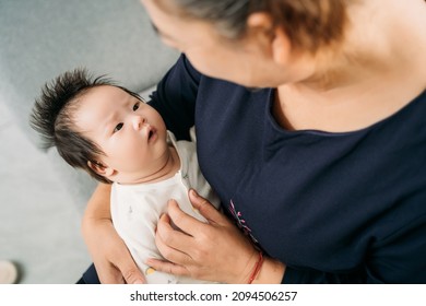 Young Grandma Holding A Newborn Baby