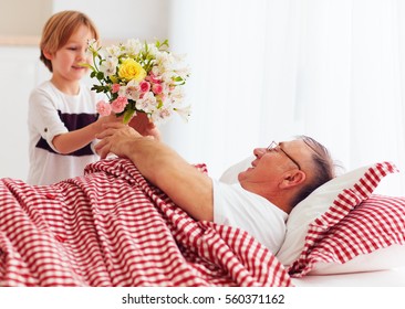 Young Grandson With Flower Bouquet Came To Visit His Sick Grandpa In Hospital Ward