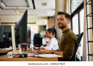 Young graphic designer using computer while working in the office.
