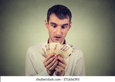 Young Greedy Business Man Counting Money