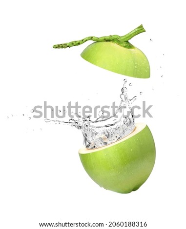 Young green coconut with coco nut water splash isolated on white background.