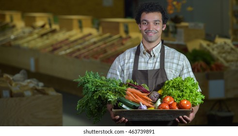 Young Grocery Clerk Working In Produce Aisle Of Grocery Store