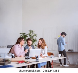 Young group of colleagues working on a new project together in a startup company office. Working in co-working space. - Powered by Shutterstock