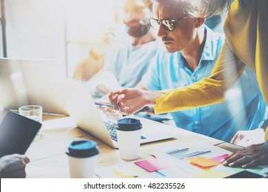 Young Group Coworkers Making Great Business Decisions.Creative Team Discussion Corporate Work Concept Studio.New Startup Idea Presentation Laptop.People Working Wood Table Documents.Blurred