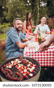 Young Group Of Friends Having A Bbq Party In The Countryside