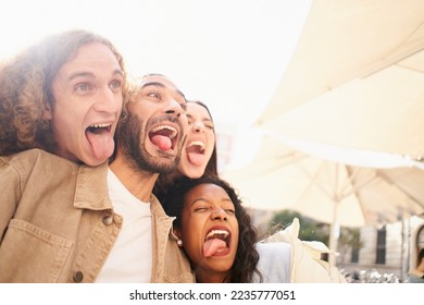 Young group of friends is making funny faces at terrace bar street outdoors. High quality photo - Shutterstock ID 2235777051