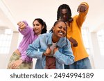 Young group of multiethnic hip-hop dancers wearing colorful urban streetwear dancing - Stylish multiracial rap crew portrait in indoors dancing studio