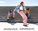 Young group of multiethnic hip-hop dancers wearing colorful urban streetwear dancing - Stylish multiracial rap crew portrait in the city