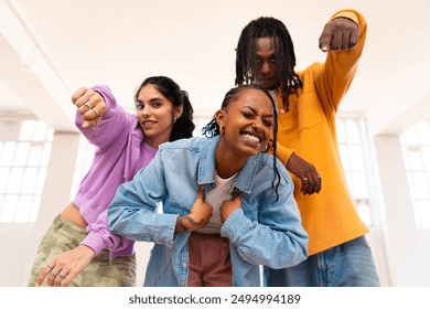 Young group of multiethnic hip-hop dancers wearing colorful urban streetwear dancing - Stylish multiracial rap crew portrait in indoors dancing studio