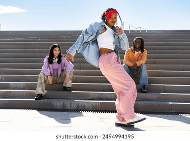 Young group of multiethnic hip-hop dancers wearing colorful urban streetwear dancing - Stylish multiracial rap crew portrait in the city