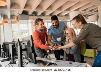 Young group of office worker joining hands in a sign of teamwork - Powered by Shutterstock