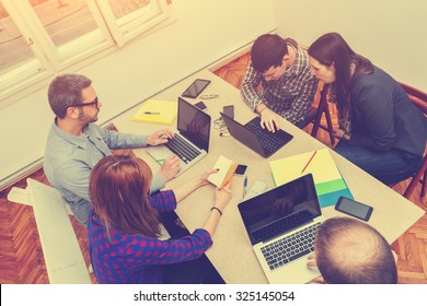 Young Group Of People Discussing Startup Business Plans.