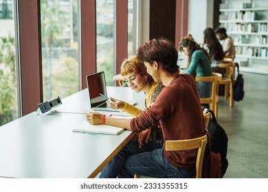 Young group of people studying inside college university library - Back to school and education concept -  Focus on student man head - Powered by Shutterstock