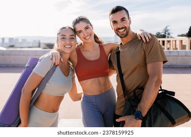 Young group of sportive friends smiling at camera standing together outdoor after workout routine. Fitness people and personal trainer occupation concept. - Powered by Shutterstock