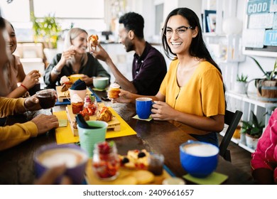 Young group of student friends having breakfast at coffee shop. People, food and beverage concept - Powered by Shutterstock