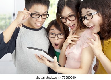young group using tablet pc and surprised