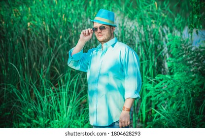 Young Guy In Blue Shirt, Fashion Outfit For Men, Clothes Concept. Man Rest At Nature In Casual Style