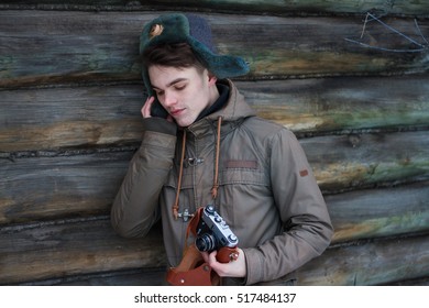 a young guy in a cap with a camera