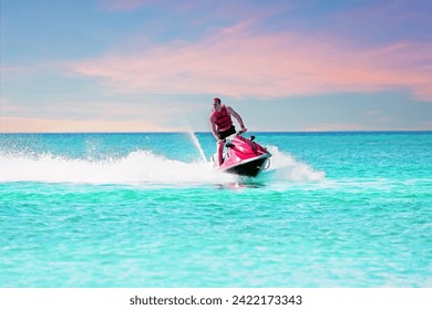 Young guy cruising on a jet ski on the caribbean sea