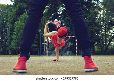 Young guy dancing breakdance on the street