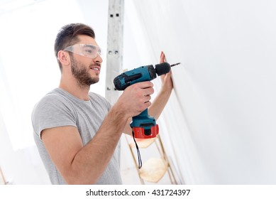 Young Guy Drilling White Wall