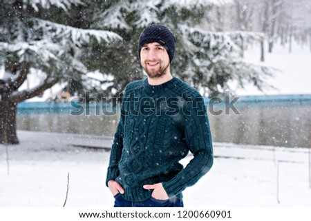 A young guy is having fun in the first snow.