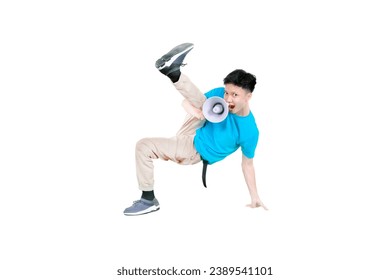 Young guy holding a megaphone while doing some acrobatic moves isolated on white background