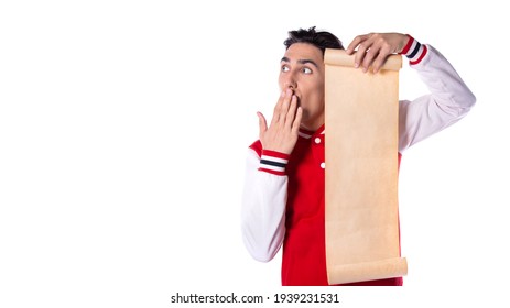 Young Guy Holding A Sheet Of Paper In Front Of Him. Long List In Hand. White Background. Copyspace.