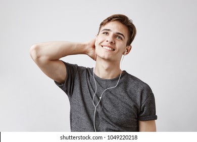 Young Guy Listening To Music Dreaming About Becoming A Famous Singer. Someday This Man Will Be A Rockstar Just Like That Singer In His Earphones. Anything Is Possible If You Try.