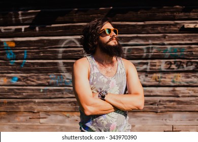 Young Guy With Long Hair Mustache And Beard Listening To Music With Headphones,young Guy With A Beard And Mustache With Glasses In The Sunlight, Fashion Man, Style, Vintage Style, Retro Men,stylish