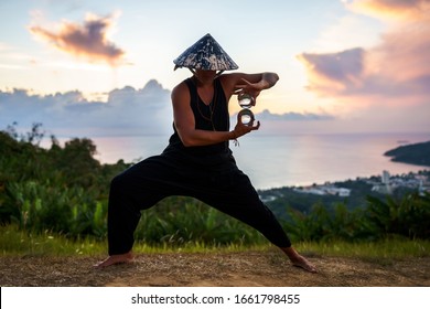 Young Guy Magician Holding A Glass Ball For Contact Juggling At Sunset