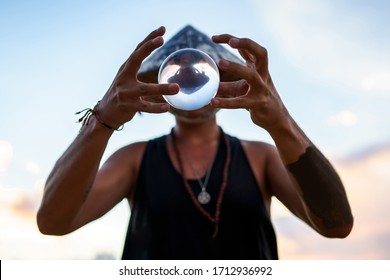 Young Guy Magician Holding A Glass Ball For Contact Juggling At Sunset