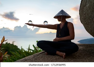 Young Guy Magician Holding A Glass Ball For Contact Juggling At Sunset