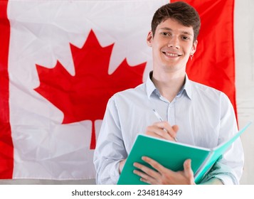 Young guy makes notes against background of - Shutterstock ID 2348184349