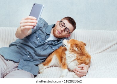 Young Guy Makes A Selfie With A Dog On His Mobile. Concept Blog