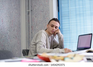 Young guy in office thinking