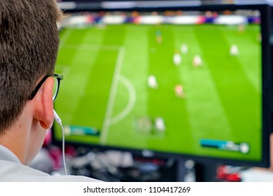 Young guy playing computer soccer. Guy watches screen. 