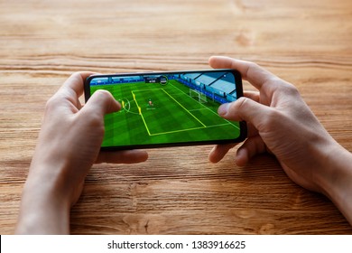 A Young Guy Plays The Fifa Mobile Game On The Phone. Smartphone Closeup Without A Face.