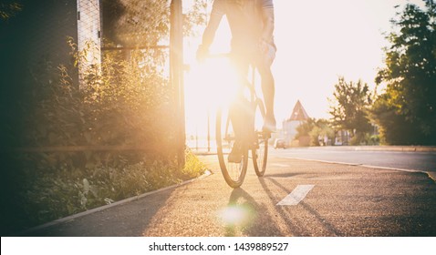 The Young Guy Is Riding The Bike Through The City