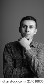 Young Guy Smiling And Holding His Chin With His Hand