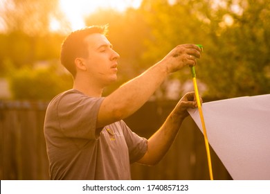 Young Guy Stained In Fuel Oil Makes An Oil Change In The Car. DIY Repair