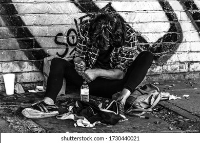 A Young Guy Taking Heroin On The Pavement In Los Angeles, Skid Row.