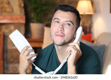 Young Guy Using Traditional Land Line Phone