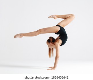 Young gymnast girl stretching and training - Powered by Shutterstock