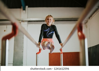 Young gymnast on parallel bars - Powered by Shutterstock