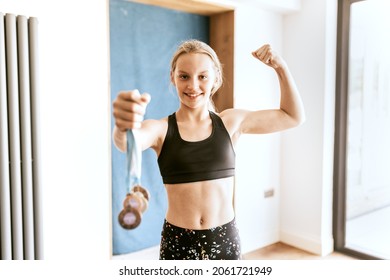 Young Gymnast Winner Holding Many Medals