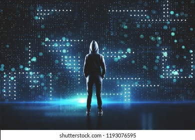 Young hacker in hoodie on abstract blurry circuit background. Malware and computing concept.