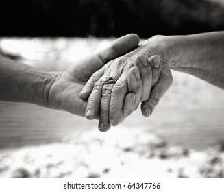 Young hand supporting old hand-helping elderly people concept - Black and White